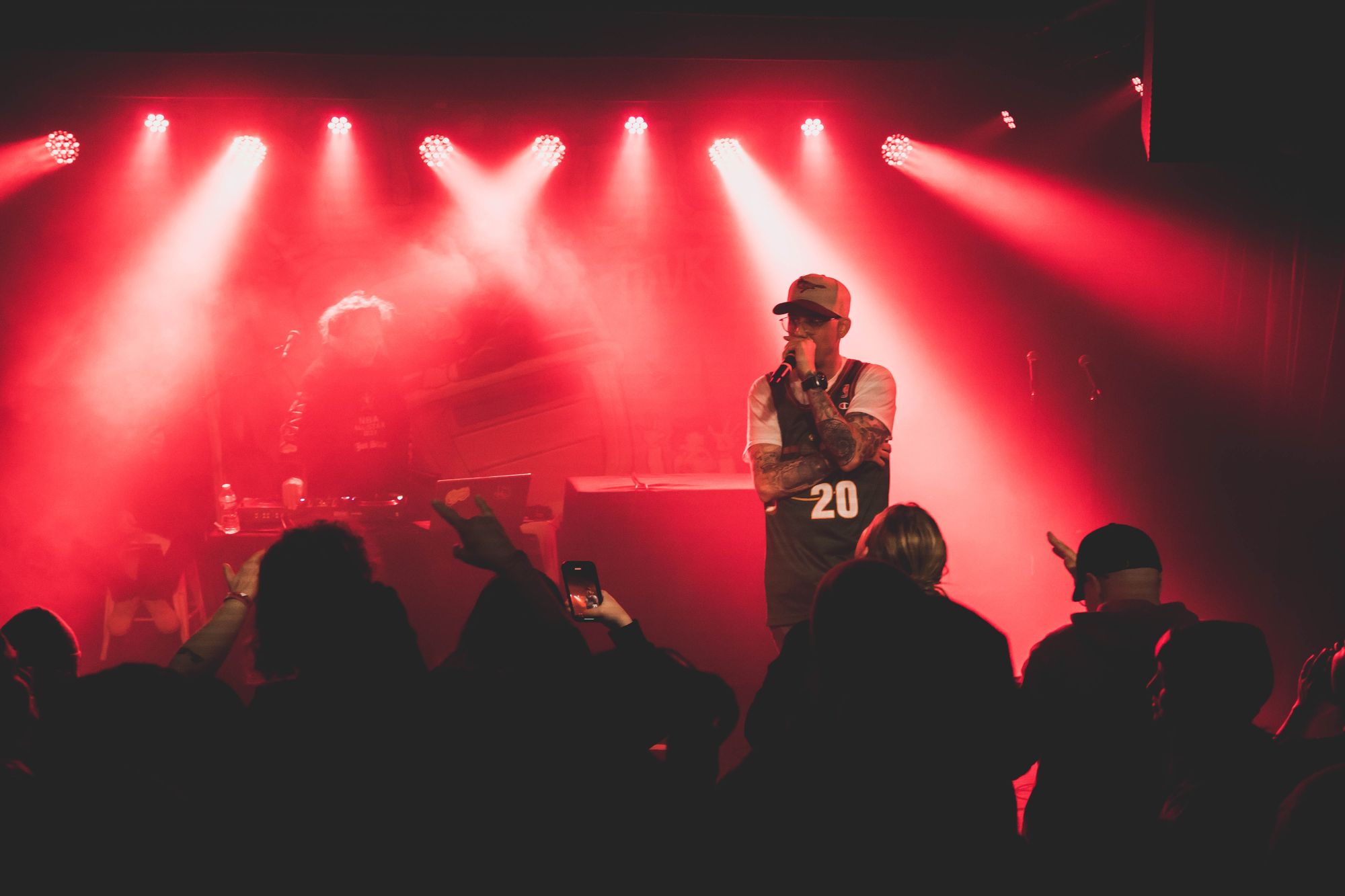 Marley B. performing live under red stage lights